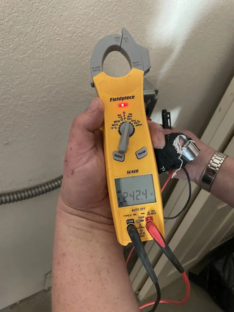 Voltage testing with clamp meter during Ceiling Fan Installation in Weaver